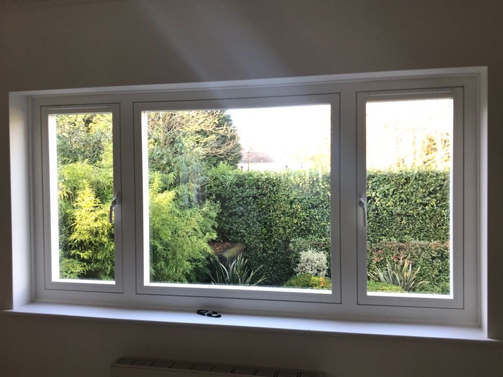 Traditional windows on white brick exterior