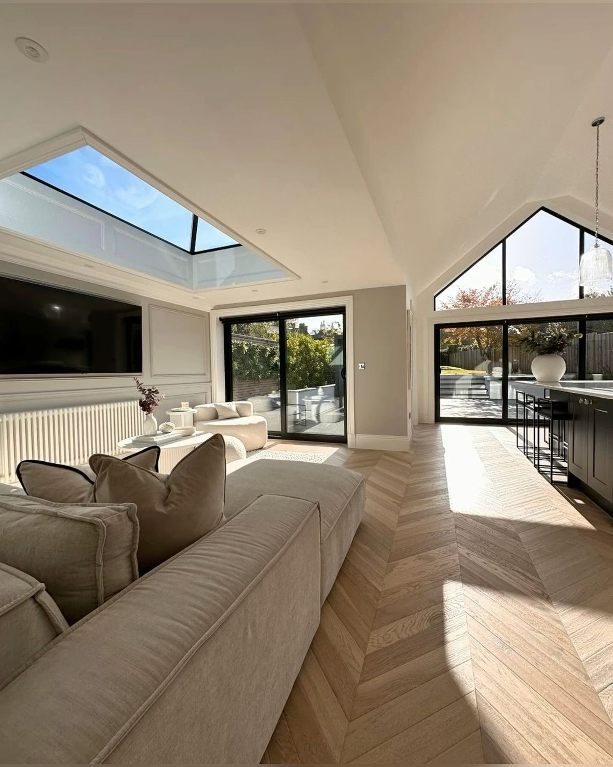Modern living room with skylights and large glass doors